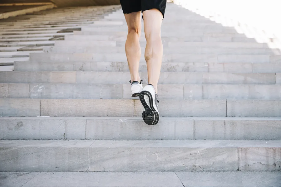 Someone partway up a flight of stairs