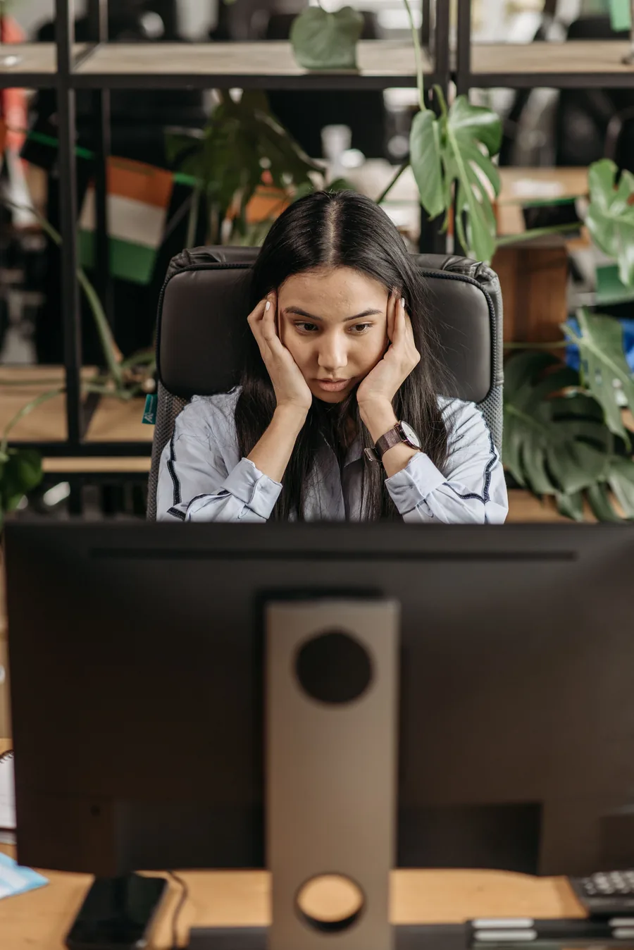 Someone pausing at a desk, tired during the day